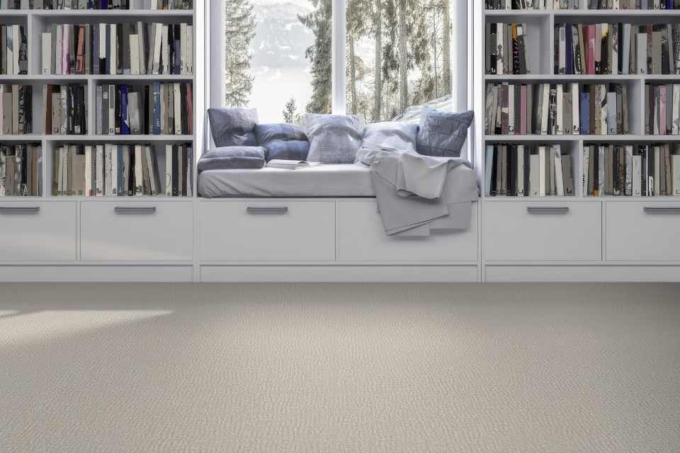 off-white patterned carpet in library with reading nook facing winter scenery